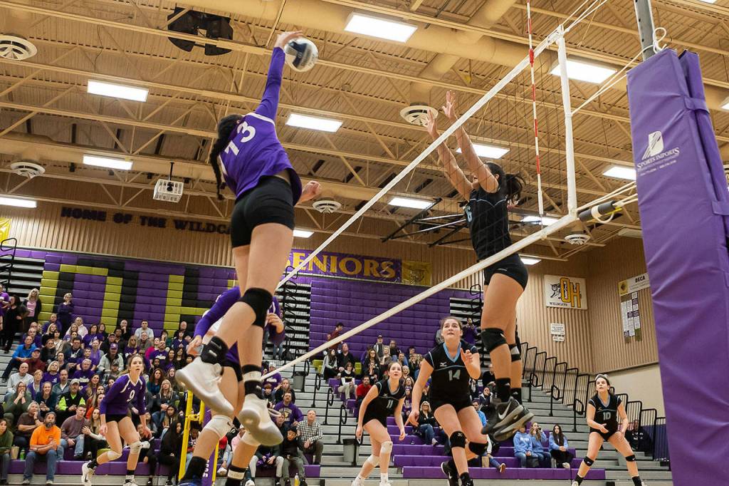 Jasmine Ford, returning after missing nearly two months with an injury, helps Oak Harbor beat Meadowdale with a kill.(Photo by John Fisken)
