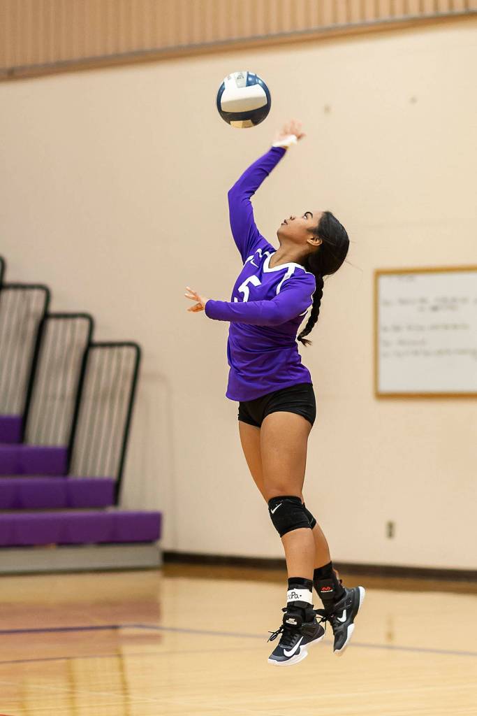 Jaslin Webster launches a serve for Oak Harbor.(Photo by John Fisken)