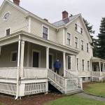 Doug Kroon stands on the porch of the old officers house at Camp Casey where his family once lived