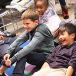 Grayson Wolniakowski answers a question about a story that had just been read to a group of third graders Tuesday night at the Prime Time reading program at Oak Harbor Library. Josh Matro laughs at the silly answer given. Photo by Laura Guido/Whidbey News-Times