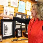 Photo by Laura Guido/Whidbey News-Times                                Jackie Vannice, president of the Whidbey Island Genealogical Searchers, points to a display the club recently established at the Oak Harbor Library to honor veterans.