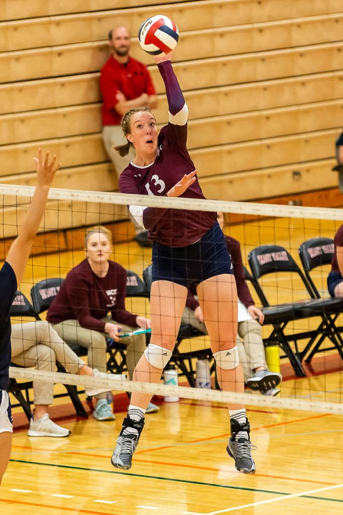 Hailee Blau goes for a kill for Whatcom College. (Photo by John Fisken)