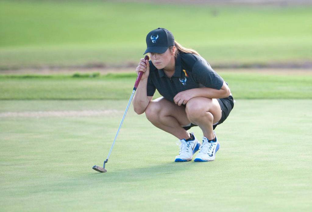 Annie Leete lines up a putt while playing for Western Washington University. (Photo courtesy of Western Washington Athletics)