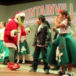 The Grinch stinks and young actors, Irving Hale and Ellie Collette, let the green grouch know it. The Grinch in Jingle Bell Jukebox is played by Kim Newcomb, who got the part when her daughter signed her up for auditions for the annual holiday show at Whidbey Playhouse. (Photo by Patricia Guthrie/Whidbey News Group)