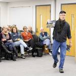 Mike Holata Monday shows the Island County Planning Commission a photo taken from his deck of the Comforts of Whidbey winery to illustrate the proximity and its impact. The public hearing on proposed rural event regulations was dominated by neighbors of the Langley winery. Photo by Laura Guido/Whidbey News Group