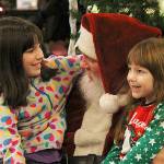 Photo by Laura Guido/ Whidbey News-Times.                                During Oak Harbors celebration on Pioneer Way Saturday, Tracy, 10, and Katelyn, 5, tell Santa Claus what they want for Christmas this year. He regrettably informed them he cannot give live animals.