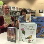 Photo provided.                                <em>Oak Harbor Teen Librarian Jessica Aws, left, and Librarian Jane López-Santillana show off some of the books that are included in the 2018 Gifts for Readers recommendation list.</em>