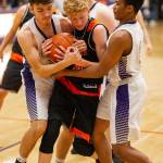 Oak Harbors Rylee Simmons, left, and TaShuan Howard tie up Blaines Cole Thomas. (Photo by John Fisken)