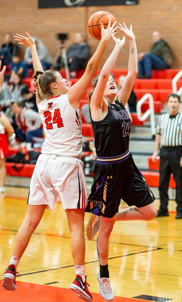 Lindsey Roberts (24) blocks Friday Harbors Piper Taylors shot.(Photo by John Fisken)