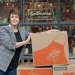 Photo by Maria Matson/Whidbey News-Times.                                <em>Oak Harbor resident Cheryl Nunn stands in front of her Coupeville shop, Collections Boutique, with boxes that will contain her next large shipment of donated womens clothing to Chico, Calif. Nunn said she is glad to be able to provide assistance using her niche industry to aid women in need after the devastating wildfires.</em>