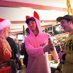 From left, Millie Goebel, Jerin Applegarth and Skip Dickinson chat in Jo Jos Harbor Light Tavern Friday night. Dressed as Mrs. Clause, the bunny suit from A Christmas Story and the Grinch, the group attended the annual Santa pub crawl, which this year included a food drive for North Whidbey Help House. Photo by Laura Guido/Whidbey News-Times