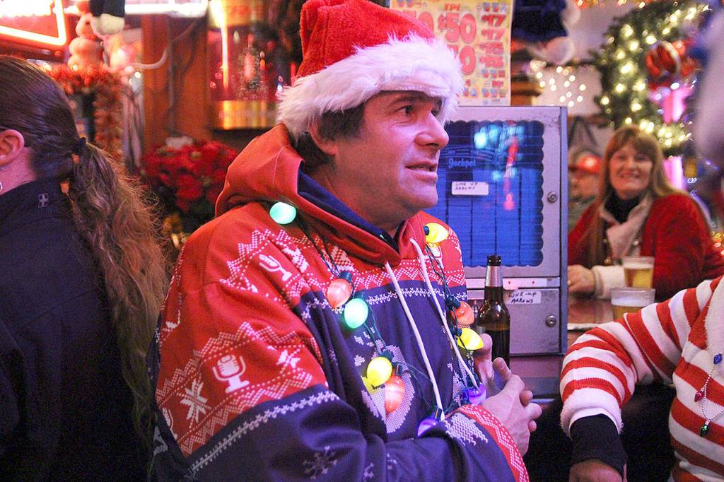 Steve Clarke, founder and organizer of the annual Santa pub crawl, sits at the bar at Jo Jos Harbor Light Tavern. This year, he decided to make the event a food drive for North Whidbey Help House. Photo by Laura Guido/Whidbey News-Times