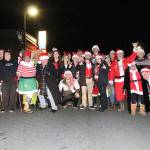 The group of Santas, Grinches, elves and more gather on Pioneer Way toward the beginning of the annual Santa pub crawl. The participates collected over 200 food items for the North Whidbey Help House at the beginning of the night. Photo by Laura Guido/Whidbey News-Times