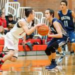 Coupeville point guard Jered Brown, left, defended by Sultans Tanner Force, gets the offense started. (Photo by John Fisken)