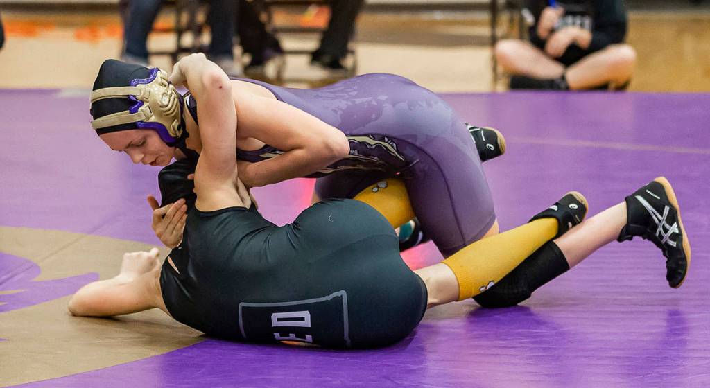Ella Erikson, top, works to turn her opponent.(Photo by John Fisken)