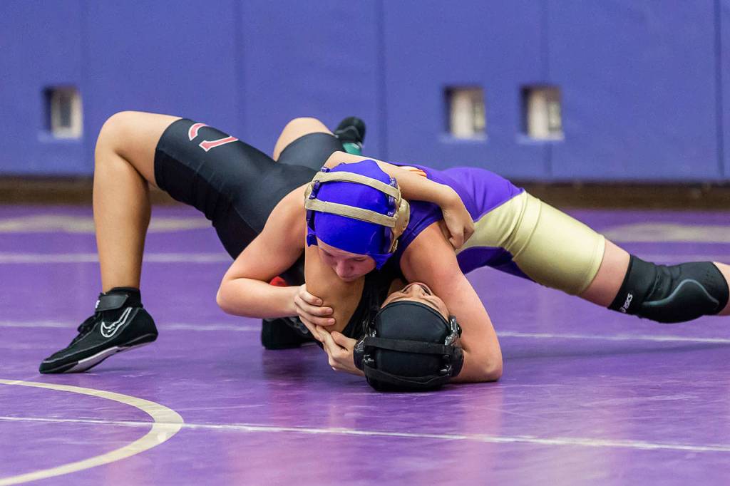 Anika Rasmussen, top, is about to record a fall for Oak Harbor.(Photo by John Fisken)