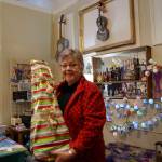 Photo by Maria Matson/Whidbey News Group                                Charlotte Gray of Whimsies holds a gift that will fulfill a girls wish in a letter to Santa. (Photo by Maria Matson / Whidbey News-Times)