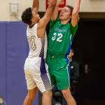 Gavin Allen puts defensive pressure on Shorewoods Spencer Osborn (32). (Photo by John Fisken)