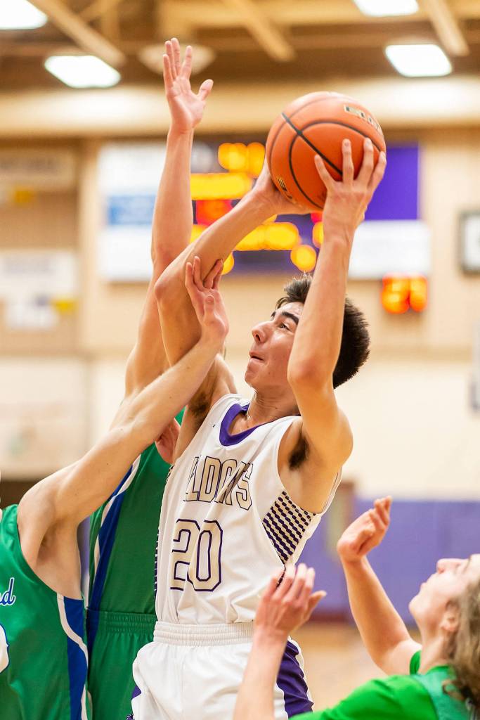 Matt Kelley fights through the Shorewood defense to take a shot in Fridays game.(Photo by John Fisken)