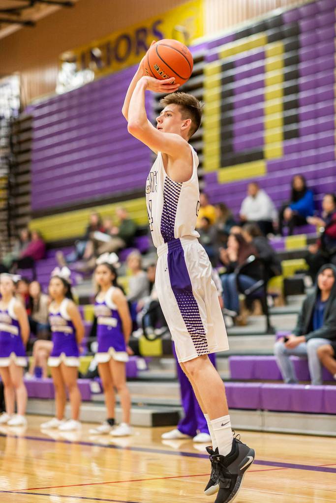 Kevin Schuldt pumps up a three-pointer against Shorewood.(Photo by John Fisken)