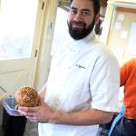 Chef and owner Tyler Hansen holds a loaf of the Oystercatchers holiday panettone a light, fruity bread. (Photo by Laura Guido/Whidbey News Times)