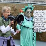 Rally organizers Linda Wehrman, left, and Pam Fick address a crowd of around 200 people at the Island County Veterans Memorial Plaza in Coupeville. The rally joined more than 700 others across the country to protest the separation of undocumented immigrant families. Photo by Laura Guido/Whidbey News-Times