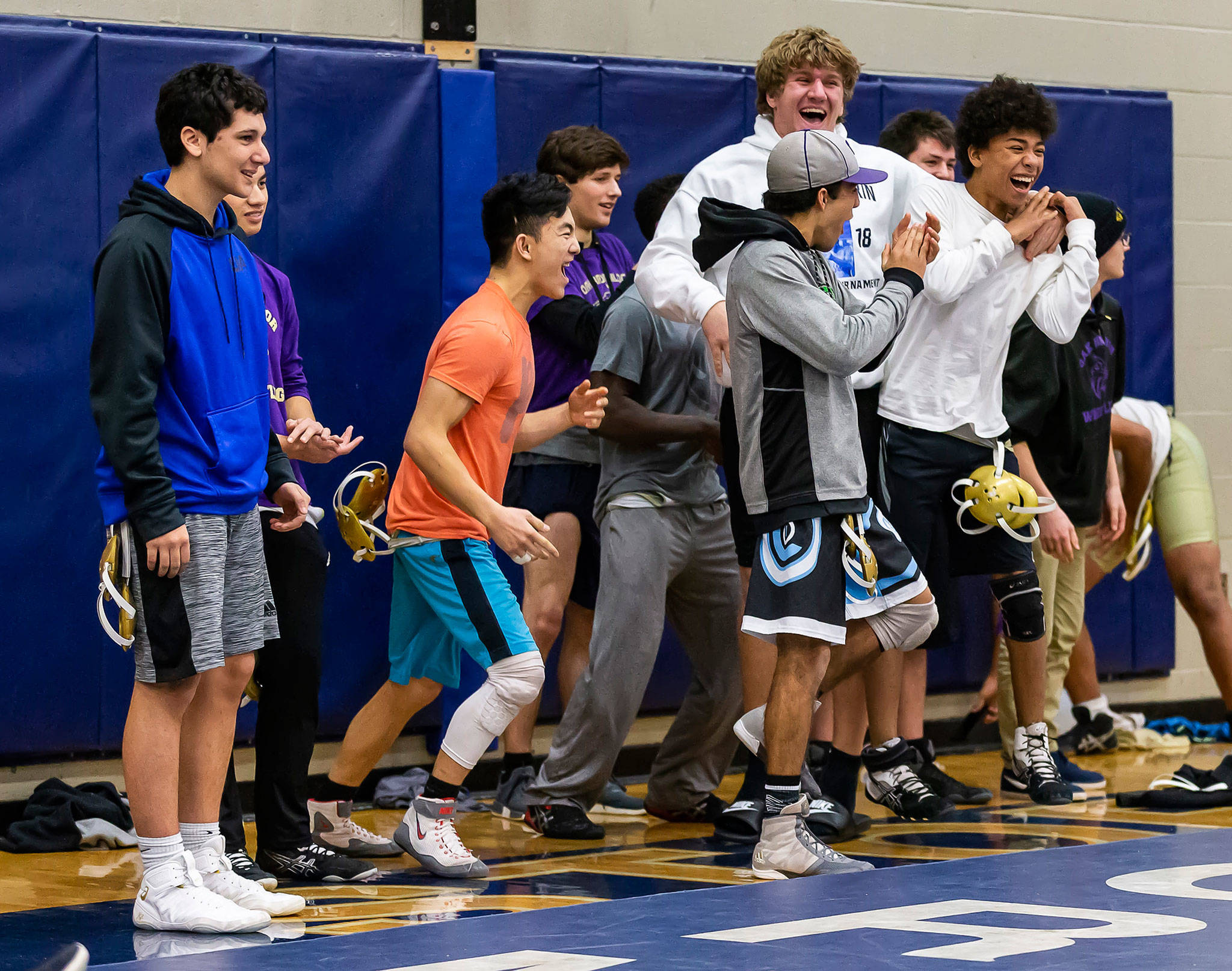 The Oak Harbor bench celebrates as teammate Nate Nunez takes down Squalicums Dominick Mack. Nunez went on to win the match over Mack, who was ranked No. 1 in the lastest 3A poll. (Photo by John Fisken)