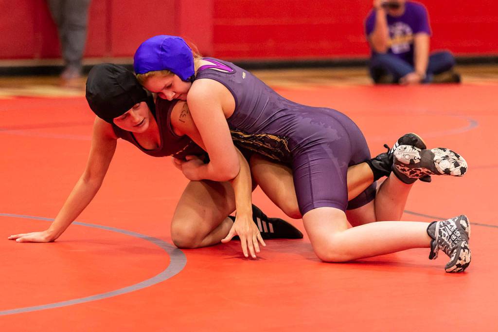 Oak Harbors Elizabeth Clairmont, right, tries to maintain control her opponent Wednesday.(Photo by John Fisken)