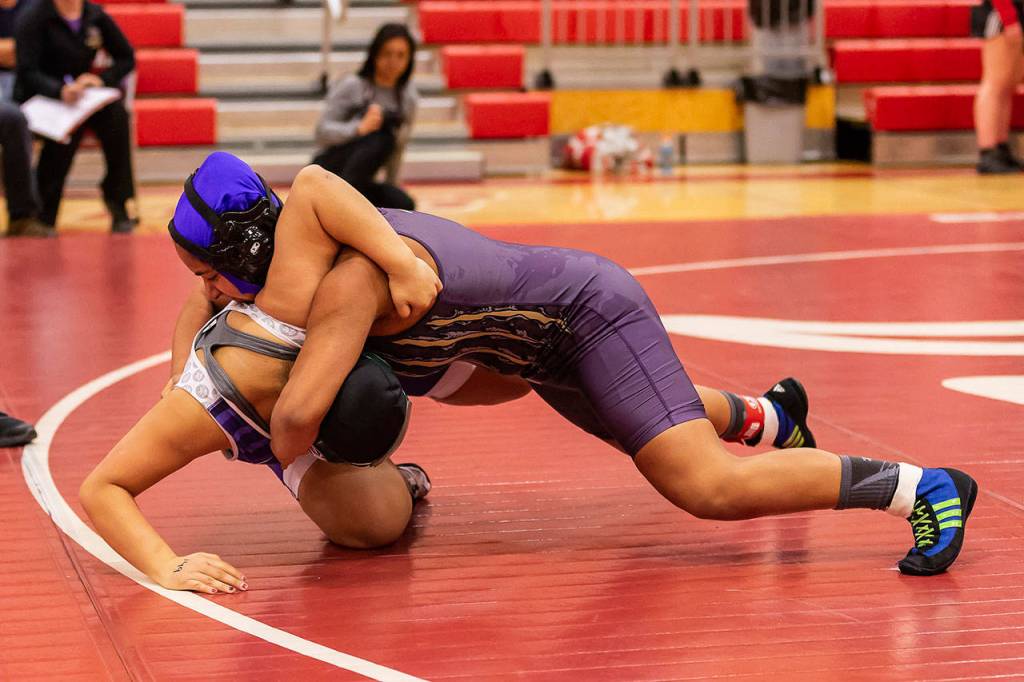 Diandra Dominguez, top, turns her opponent on the way to a ssecond-round pin.(Photo by John Fisken)