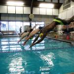 Members of the Oak Harbor High School swim team dive off the blocks into the pool Thursday afternoon. There was uncertainty as to whether the team would have a place to practice before the North Whidbey Pool, Park and Recreation district levy passed in November. Photo by Laura Guido/Whidbey News-Times