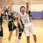 Gavin Allen flips up a left-handed shot against Mount Vernon. (Photo by John Fisken)