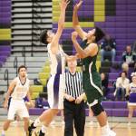 Matt Kelley, left, takes the opening tip for Oak Harbor. (Photo by John Fisken)
