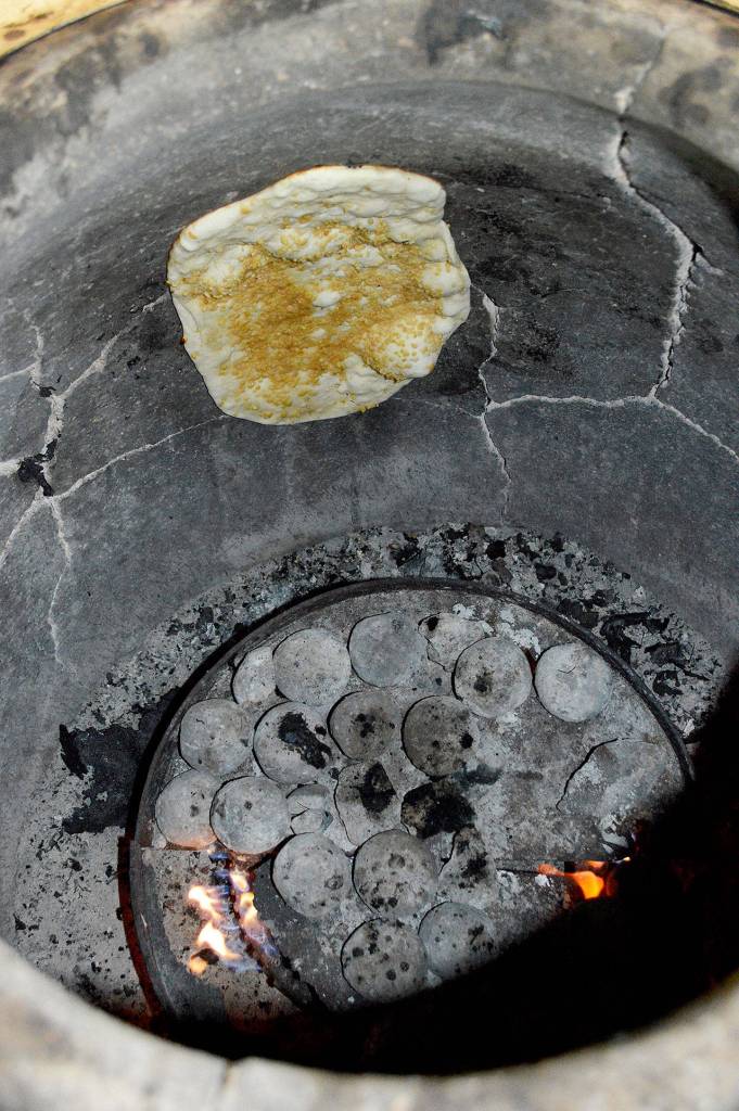 Naan cooks in a clay tandoori oven, a staple of northern Indian food.