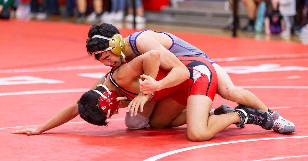 Jakob Dailey, top, controls Snohomishs Jayme Gonzales.(Photo by John Fisken)