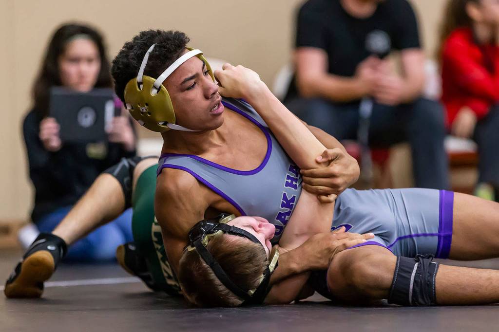 Jamal Graham, top, is about to pin Timberlines Brett Beauchamp.(Photo by John Fisken)