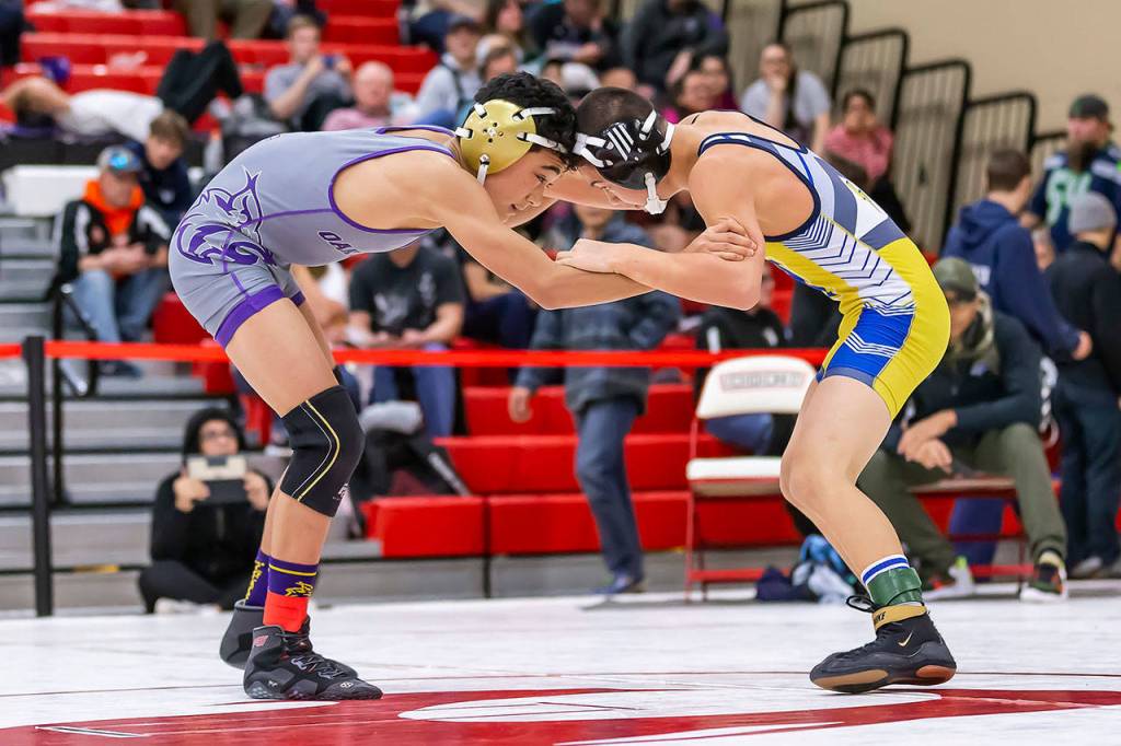 Cole Valdez, left, tangles with Hazens Erik Nguyen.(Photo by John Fisken)