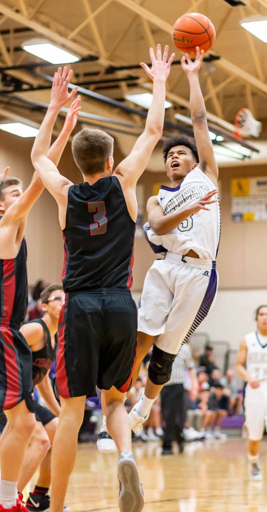 Terrell Crumpton, right, shoots over the defense of Cedarcrests Bryce Hefner.(Photo by John Fisken)