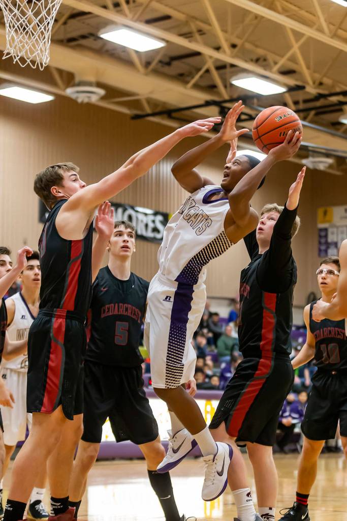 Dorian Hardin draws a crowd of defenders on his way to the hoop.(Photo by John Fisken)