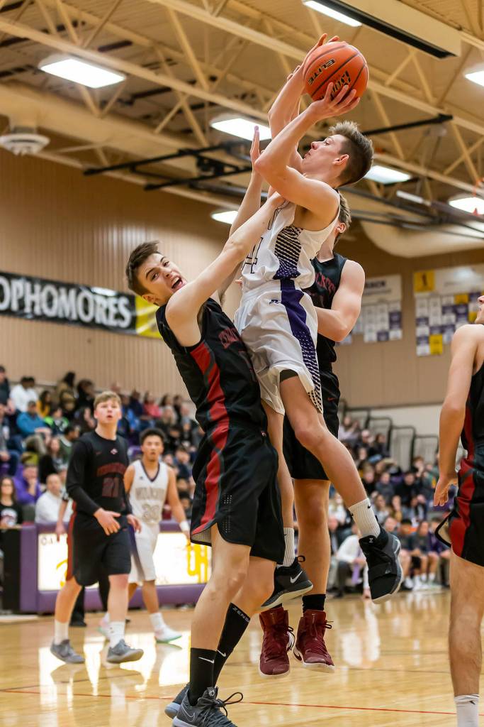 Kevin Schuldt battles through a pair of Cedarcrest defenders.(Photo by John Fisken)