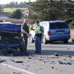 Deputy Lane Campbell and Washington State Trooper Joshua Lancaster assess damage after an accident on Highway 20 near Arnold Road on Monday afternoon. Photo by Laura Guido/Whidbey News-Times