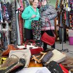Garage of Blessings founder Kristiina Miller and her daughter Chloe Miller stand surrounded by recently donated purses and clothing. The items will be given away at a special event on Jan. 19. Photo by Laura Guido/Whidbey News-Times