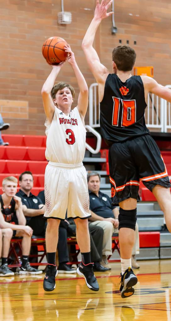 Mason Grove fires up a three-ball in Tuesdays game. Grove hit four from long range in the Wolves win.(Photo by John Fisken)