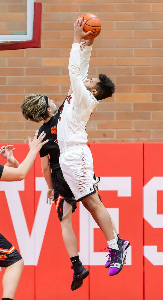 Jacobi Pilgrim leaps for a rebound. (Photo by John Fisken)