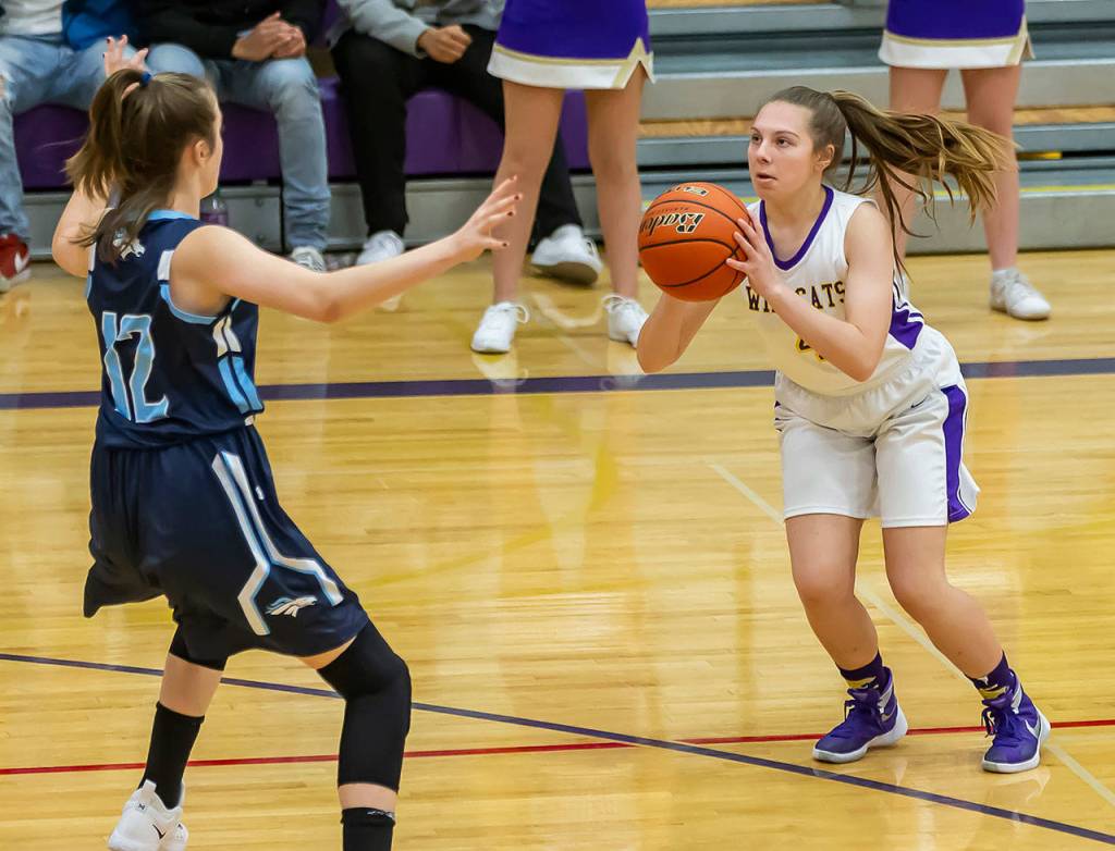 Sami Olson puts up a three-pointer in front of Meadowdales Maia Austvold.(Photo by John Fisken)