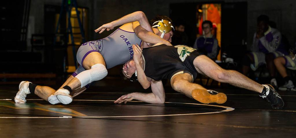 Oak Harbors Blake McBride, left, turns Matt Paquette for a pin.(Photo by John Fisken)