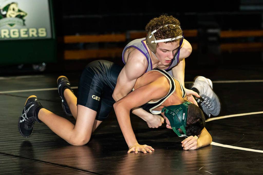 Oak Harbors Shamus Warden, top, takes control of his match with Omar Salcedo.(Photo by John Fisken)