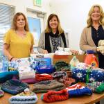 Island County Human Services staff members Wendy Beagle, Kathryn Clancy and Joanne Pelant show donated items the agency has received. They work with a number of disaffected people in the community and give the items away to those that need them. Photo by Laura Guido/Whidbey News Group