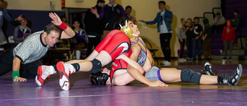 The official is about to slap the mat to signifiy that Cole Valdez, right, has pinned Snohomishs Bryce Skowron.(Photo by John Fisken)