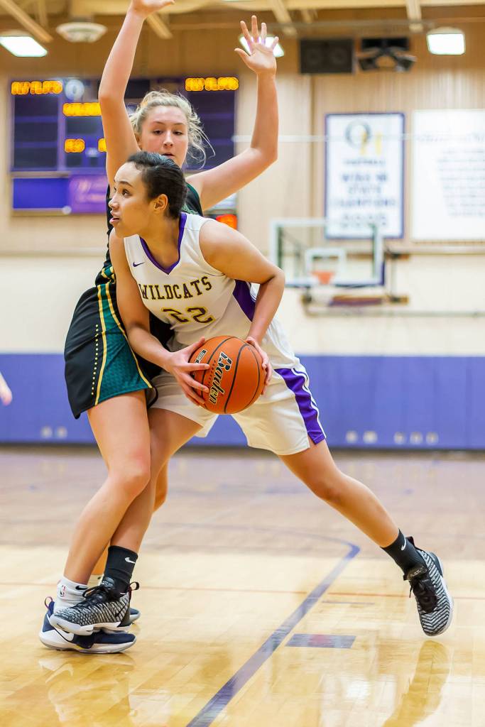 Jasmine Ford, right, tries to step around the defense of the Scots Audrey Dietz.(Photo by John Fisken)