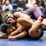Oak Harbors Ella Erikson, top, competes in the Arlington tournament Saturday. Erikson finished second in the 115-pound class. (Photo by John Fisken)